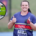 South African athlete Colette Uys winding up for a shot put throw during a competition. She is wearing Tuks athletic colors and appears focused on technique.